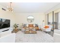 Bright living room with modern furnishings and a large sliding glass door to balcony at 330 Concord St # 4A, Charleston, SC 29401