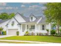 Charming white two-story home with inviting front porch and well-manicured lawn at 3439 Toomer Kiln Cir, Mount Pleasant, SC 29466