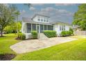 Expansive backyard with stone patio and screened porch, perfect for outdoor entertaining at 3439 Toomer Kiln Cir, Mount Pleasant, SC 29466