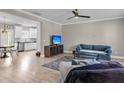 Cozy living room open to kitchen, featuring hardwood floors, ceiling fan, and comfortable seating at 3447 Yarmouth Dr, Mount Pleasant, SC 29466
