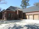 A beautiful brick home boasts a spacious three-car garage and concrete driveway at 404 Fairington Dr, Summerville, SC 29485