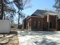 The home is a brick facade with black trim windows, complemented by a concrete driveway at 404 Fairington Dr, Summerville, SC 29485