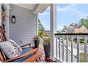 Cozy porch with rocking chairs, decorative pillows, and neighborhood views at 482 Sanders Farm Ln, Wando, SC 29492