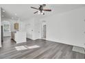 Open-concept living room featuring modern gray flooring, recessed lighting, and a ceiling fan for a bright and airy feel at 4856 Cane Pole Ln, Summerville, SC 29485