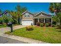 Inviting single-Gathering home with a manicured lawn, mature trees, and a welcoming front porch at 5008 Bowles Dr, Summerville, SC 29485