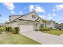 Beautiful home boasts an attached garage, brick and siding exterior, manicured landscaping, and a paved driveway at 523 Fern Tree Dr, Summerville, SC 29486