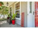 Inviting front porch area with plants, bench seating, and a 'Welcome' sign creating a warm entry at 5401 Diston Court, North Charleston, SC 29420