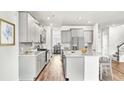 Modern kitchen features gray cabinets, stainless steel appliances, and an island with counter seating at 549 Richfield Way Way, Summerville, SC 29486