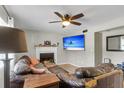 Spacious living room with a fireplace, modern ceiling fan, and a comfortable leather sofa at 565 Travelers Blvd, Summerville, SC 29485