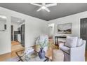 Inviting living room with hardwood floors, neutral tones, and seamless access to kitchen at 5817 Canterbury Dr, Hanahan, SC 29410