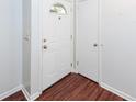 Bright entryway featuring wood-look flooring, a white front door, and a coat closet for storage at 7655 Ovaldale Dr, North Charleston, SC 29418