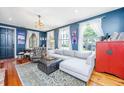 Comfortable living room features a plush sectional, wingback chair, and hardwood floors at 9 Bogard St # 3, Charleston, SC 29403