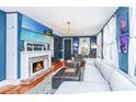 Inviting living room with a fireplace, TV, stylish furniture, and hardwood floors at 9 Bogard St # 3, Charleston, SC 29403