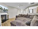 Cozy living room featuring a fireplace, a ceiling fan, and a large sectional couch creating a relaxing atmosphere at 9676 Godwin St, Ladson, SC 29456