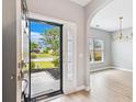 Inviting entryway showcasing an open floor plan with hardwood floors leading to a dining area with natural light at 1007 Halfacre Ln, Ladson, SC 29456
