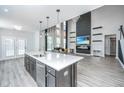 Open-concept living space featuring a sleek fireplace, high ceilings, and seamlessly connected to the modern kitchen at 101 Firebrick Way, Summerville, SC 29483