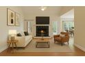 Cozy living room with a fireplace, vaulted ceiling, and ample natural light from the surrounding windows at 103 Innisbrook Bnd, Summerville, SC 29483