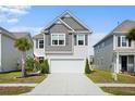 Traditional two-story home with a two-car garage, manicured lawn, and neat landscaping enhancing curb appeal at 1052 Sago Palm Ct, Mount Pleasant, SC 29429