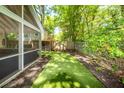 Fenced backyard with artificial turf, a play area, and screened-in porch at 1070 Blue Marlin Dr, Charleston, SC 29412