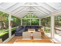 Screened-in porch boasting a large sectional sofa, coffee table, and outdoor seating at 1070 Blue Marlin Dr, Charleston, SC 29412