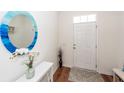 Bright and modern foyer with hardwood floors, a round mirror, and a stylish console table at 118 Alpine Rd, Summerville, SC 29485