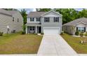 Charming two-story home featuring a large driveway and an attached garage at 131 Cloverleaf St, Summerville, SC 29483