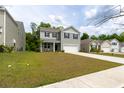 Well-maintained two-story home with a wide driveway and lush green lawn at 131 Cloverleaf St, Summerville, SC 29483