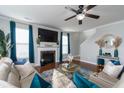 Inviting living room featuring a cozy fireplace, stylish decor, and plenty of natural light at 138 Shadybrook Dr, Summerville, SC 29486