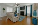 Comfortable living room featuring a fireplace, hardwood floors, and neutral decor at 138 Shadybrook Dr, Summerville, SC 29486