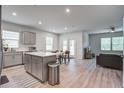 Open-concept kitchen and dining area with wood floors, stainless appliances, and an island at 143 West Bradford Pointe Dr, Summerville, SC 29486