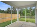 Relaxing screened porch offering views of the fenced backyard and lush landscaping at 143 West Bradford Pointe Dr, Summerville, SC 29486