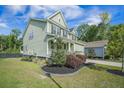 Landscaped front yard of a two-story home with stone edging at 1489 Brockenfelt Dr, Charleston, SC 29414