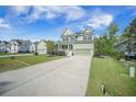 Traditional two-story home with a concrete driveway and manicured lawn at 1489 Brockenfelt Dr, Charleston, SC 29414