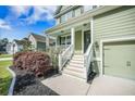 Inviting front porch with white railings and freshly landscaped garden beds at 1489 Brockenfelt Dr, Charleston, SC 29414