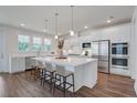 Bright, modern kitchen features a large center island, stainless steel appliances, and sleek white cabinetry at 1619 Cultivation Ln, Mount Pleasant, SC 29466