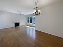 Bright and airy living room with hardwood floors, fireplace, and large windows offering ample natural light at 1622 Pin Oak Cut, Mount Pleasant, SC 29466
