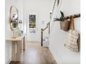 Hallway with a wooden table, lamps and decorative mirror next to a staircase and a doorway at 1664 Siloh St # 471, Mount Pleasant, SC 29466