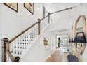 Bright staircase with white railings, wooden handrail, leading to a second floor with abundant natural light at 1664 Siloh St # 471, Mount Pleasant, SC 29466