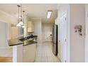 Well-lit kitchen featuring modern appliances, granite counters and tile flooring at 1984 Folly Rd # A307, Charleston, SC 29412