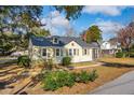 Charming two-story home with light yellow siding, gray roof, green shutters, and a cozy screened-in porch at 2178 Fort Pemberton Dr, Charleston, SC 29412