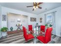 Open-concept dining space with glass table, red chairs, and view of the entryway at 224 Hayworth Rd, Summerville, SC 29486