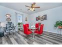 Bright dining area showcasing a modern glass table, red chairs, and elegant decor at 224 Hayworth Rd, Summerville, SC 29486