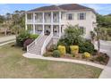 Expansive exterior of this two-story home with lush landscaping and a charming, inviting aesthetic at 2269 Hartfords Bluff Cir, Mount Pleasant, SC 29466
