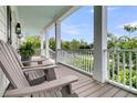 Cozy porch with comfortable seating, ideal for enjoying the peaceful neighborhood scenery and outdoor living at 2269 Hartfords Bluff Cir, Mount Pleasant, SC 29466