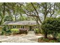 Traditional home nestled among mature trees with lush greenery and updated front stairs at 2355 Andell Way, Seabrook Island, SC 29455