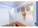 Traditional entryway with paneled walls, hardwood floors, bench and stairway at 24 Archdale St, Charleston, SC 29401