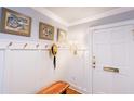 Light and airy entryway featuring a white front door, hardwood floors, and paneled walls at 24 Archdale St, Charleston, SC 29401