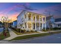 Charming two-story home featuring double porches, mature landscaping, and sidewalk at 282 Great Lawn Dr, Summerville, SC 29486