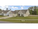 Charming home with a well-manicured lawn and a two-car garage at 3154 Hugh Bennett Dr, Johns Island, SC 29455