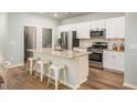 Bright kitchen with stainless steel appliances, granite countertops, and a large island with seating for four at 325 Pine Crest View, Summerville, SC 29486